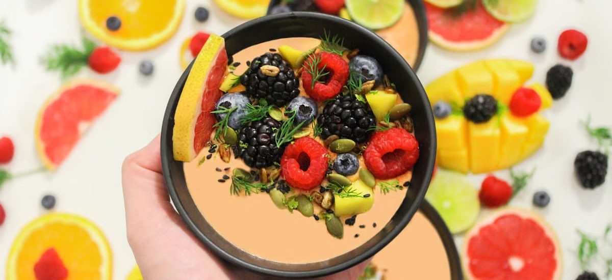 Colorful bowl of fresh fruits with a mix of berries and seeds, perfect for a healthy meal.